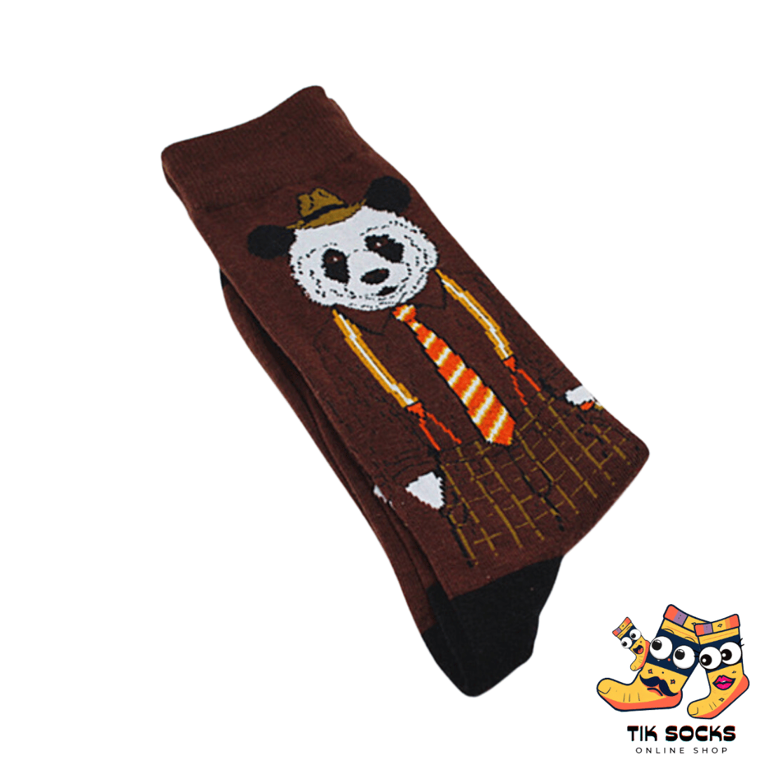 Men's and women's socks decorated with illustrations of pandas in various playful poses, munching on bamboo or lounging, set against a green or natural background