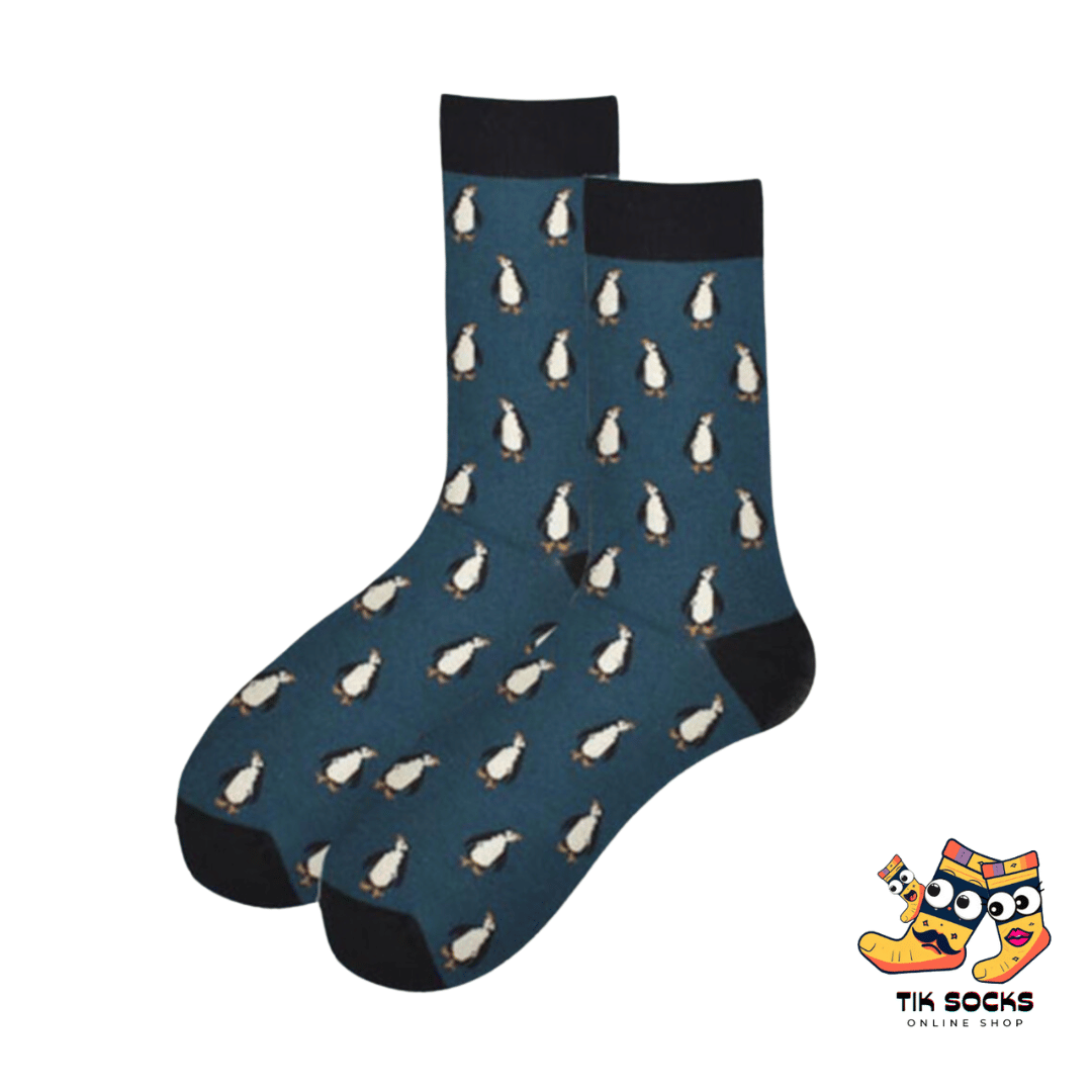 Men's and women's socks featuring adorable penguins, waddling or sliding, set against a snowy or icy blue background