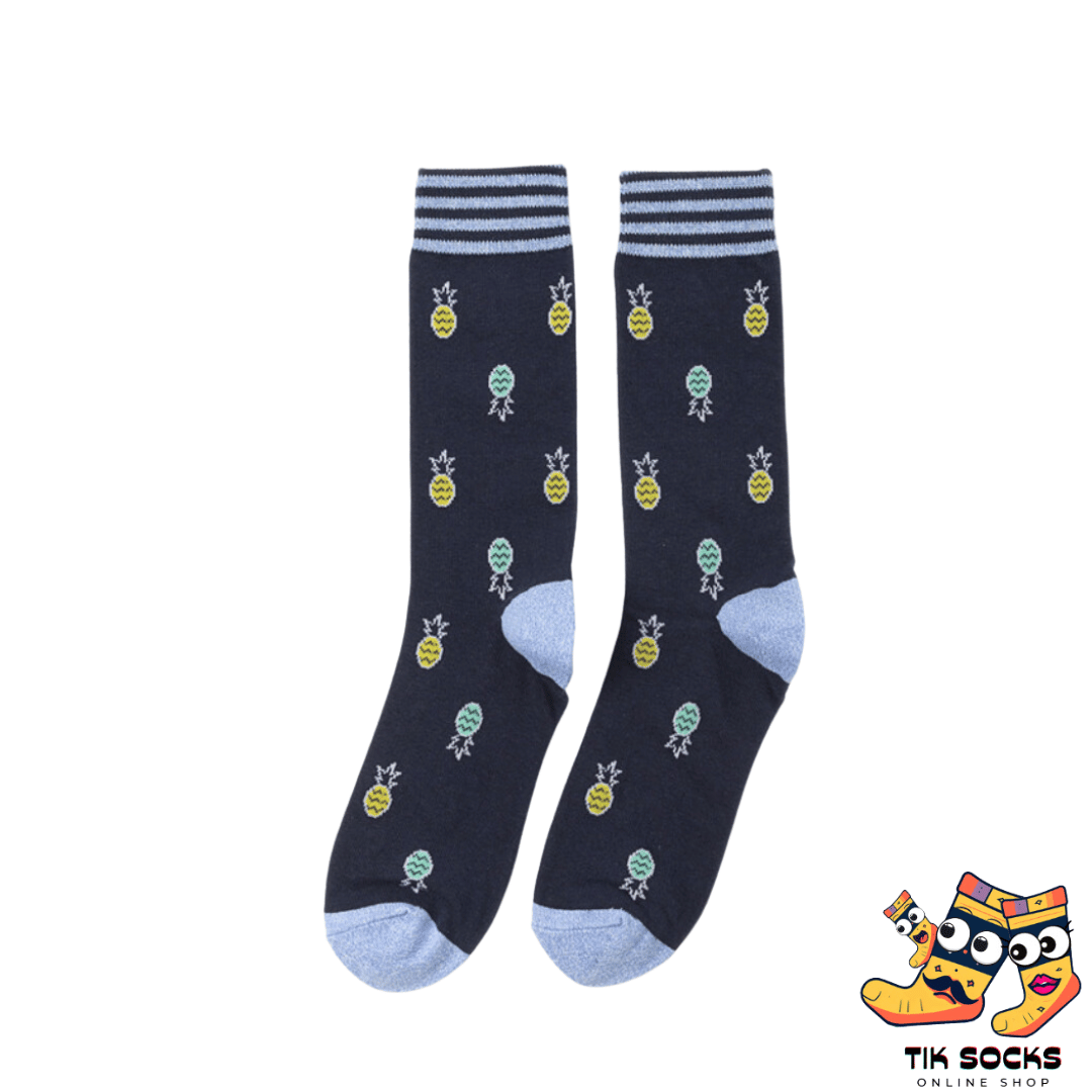 Men's and women's socks featuring vibrant graphics of pineapples, both whole and sliced, set against a tropical-themed background