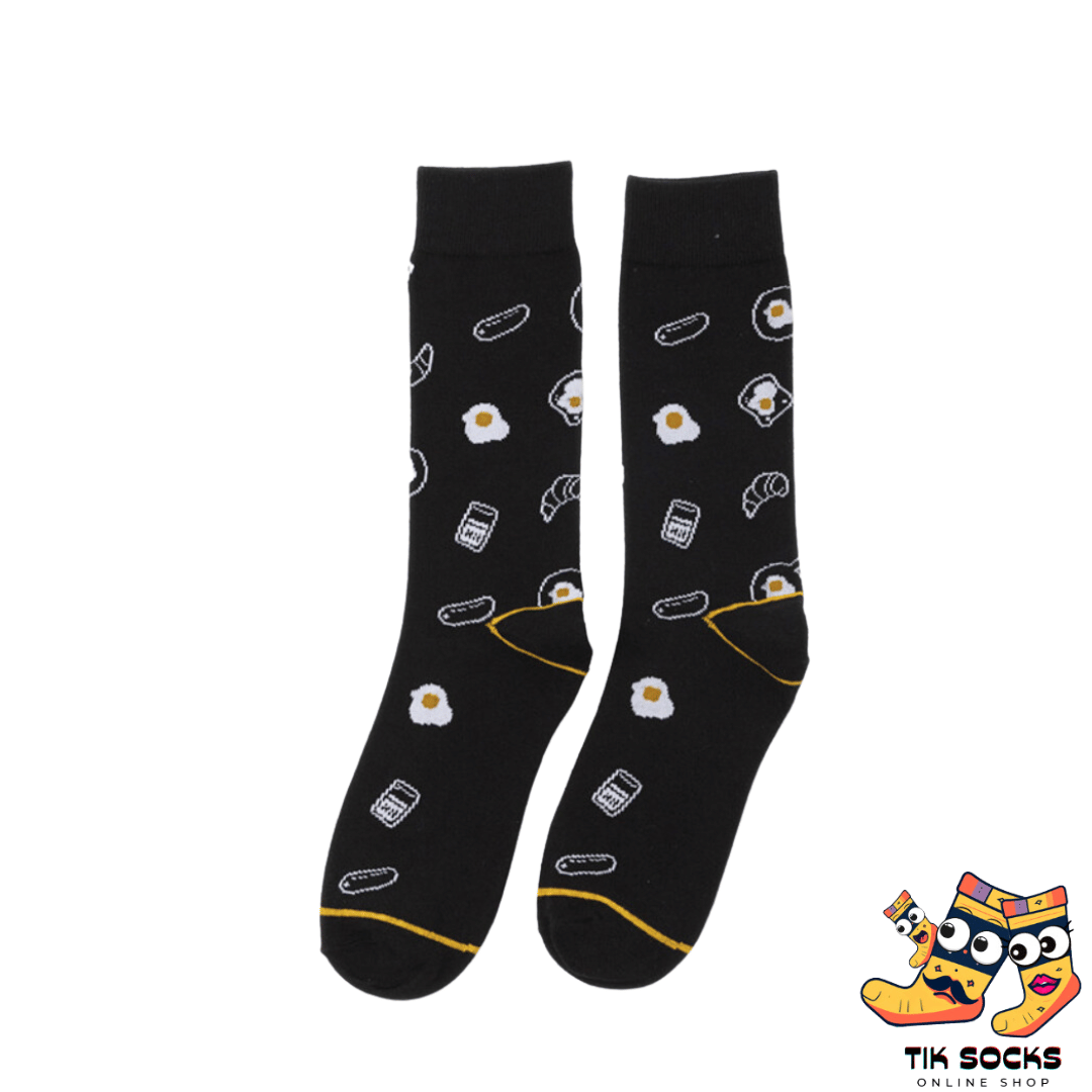Men's and women's socks showcasing a design of poached eggs with runny yolks, set against a neutral background