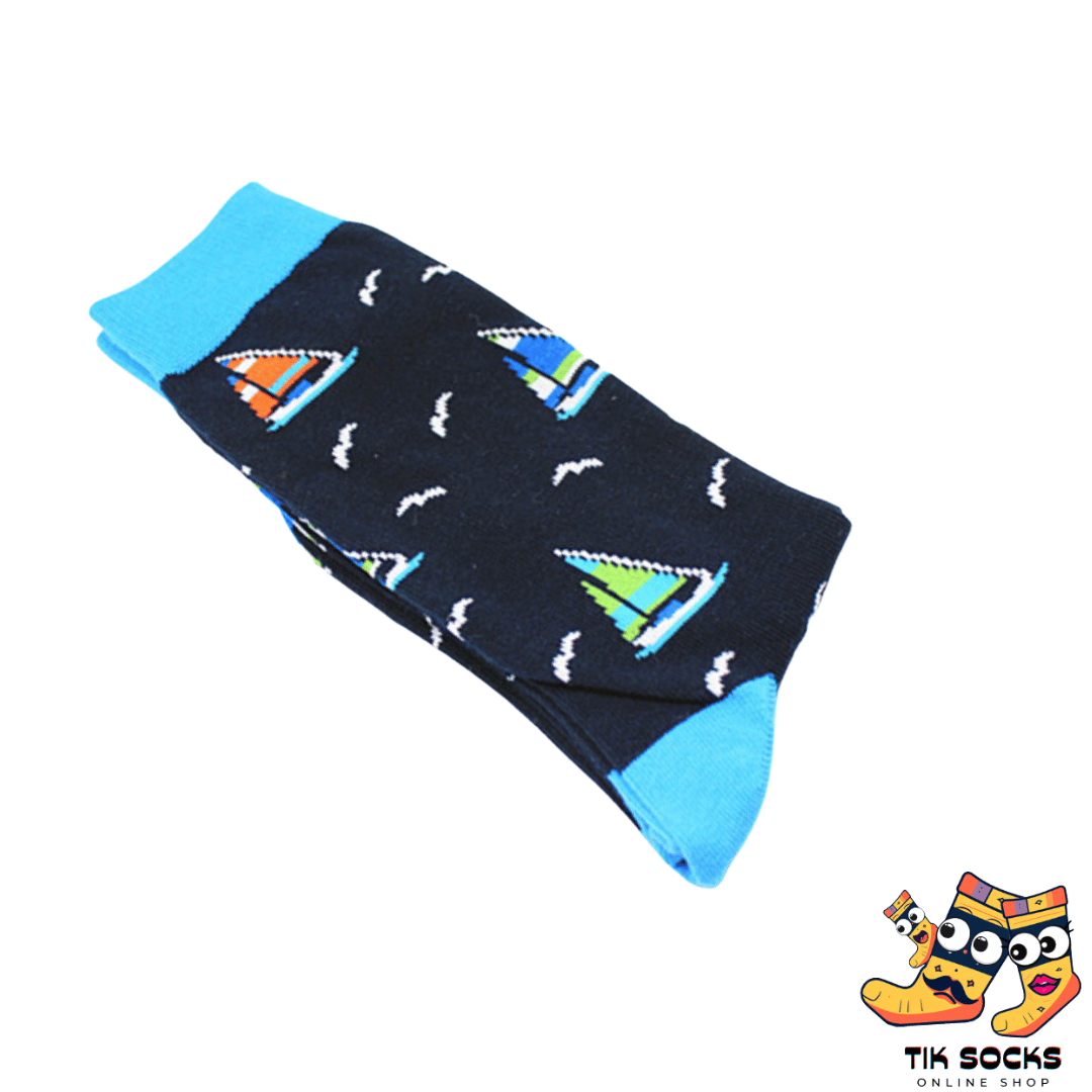 Men's and women's socks featuring illustrations of sailboats gracefully gliding on serene waters, set against a scenic seascape