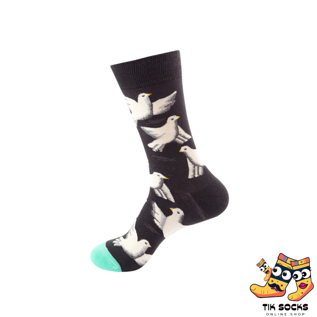 Men's and women's socks adorned with illustrations of pigeons in various poses, either perched or in flight, set against an urban or park-themed background