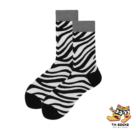 Pair of socks on a yellow background featuring a zebra design
